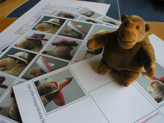 Mr Monkey with the four sheets of parts for the memory game