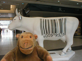 Mr Monkey with a white cow marked by a large bar code
