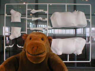 Mr Monkey in front of a giant kit of a cow