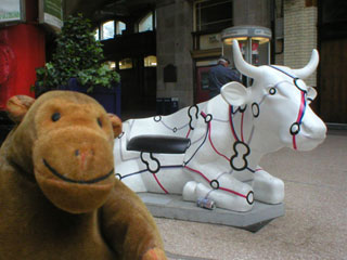 Mr Monkey with a seated cow, decorated with a railway line schematic