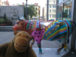 Mr Monkey with a brightly patterned cow