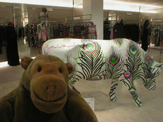 Mr Monkey with a cow decorated with peacock plumes
