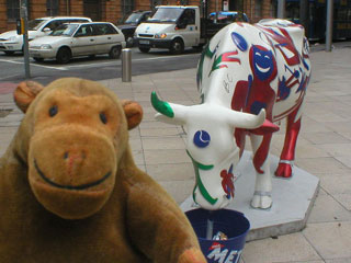 Mr Monkey with a white cow covered in red figures