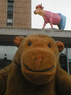 Mr Monkey below a cow dressed in a Indian male costume