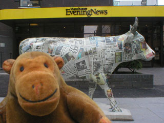 Mr Monkey with a cow covered in newspapers