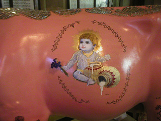Detail of the child and jars on the side of the Mother Cow