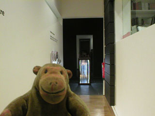 Mr Monkey looking up the corridor to the main gallery