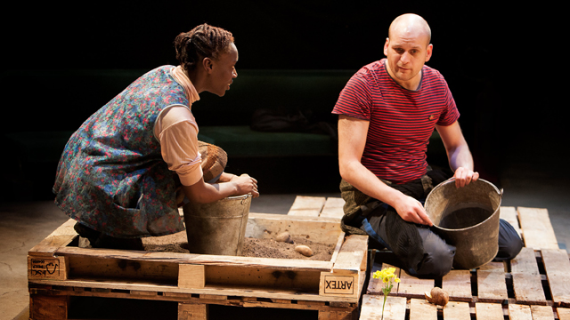 Lizaveta (Ony Uhiara) and Josef (Ricky Champ) harvesting potatoes (Royal Exchange Theatre production photo)