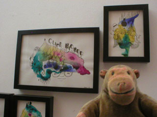 Mr Monkey looking at small drawings by TXLW