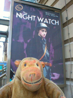 Mr Monkey looking at the The Night Watch poster