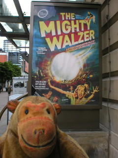 Mr Monkey looking at the The Mighty Walzer poster
