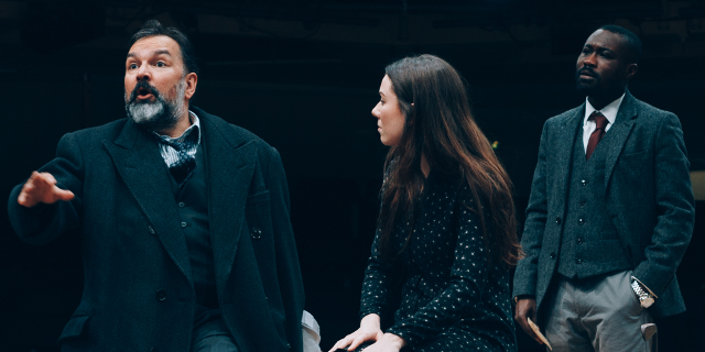 Julius D'Silva as Boris Borisovich Simyonov-Pischik, Verity Blyth as Anya, and Jude Owusu as Yermolai Alekseyevich Lopakhin. (Production photo by Liam Bennett)