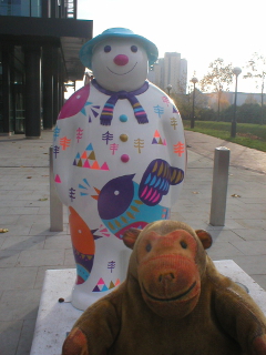 Mr Monkey looking at the Four Calling birds snowman