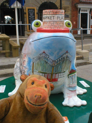 Mr Monkey looking at This Little Froggy Went to Market frog