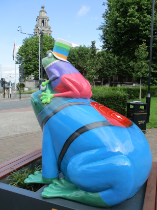 Dr Frog from the side, with the town hall in the distance