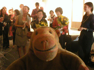 Mr Monkey listening to Cathy Wu and Mary Tang talking about their work
