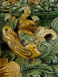 The head of a dragon adorning an incense burner