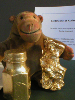 Mr Monkey examining his golden objets d'art