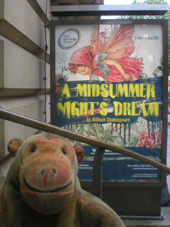 Mr Monkey looking at the A Midsummer Night's Dream poster outside the theatre