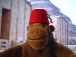 Mr Monkey wearing his fez in some ruins