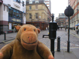 Mr Monkey examining a replica water pump in Soho