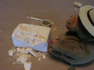 Mr Monkey chipping the side of the block away