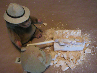 Mr Monkey and Mr Cat levering the terracotta warrior out of his block