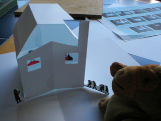 Mr Monkey adding a roof to the building