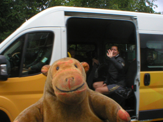 Mr Monkey watching someone waving from one of the support vans