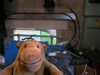 Mr Monkey examining the gearing and generator on one of the Archimedes screws.