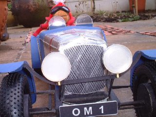 Mr Monkey driving in woolly hat and scarf