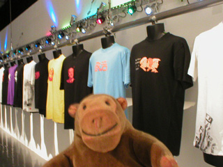 Mr Monkey looking at a row of t-shirts