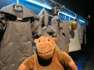 Mr Monkey looking at a row of clothes by Wang Yiyang