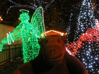 Mr Monkey looking at illuminated angels in Albert Square