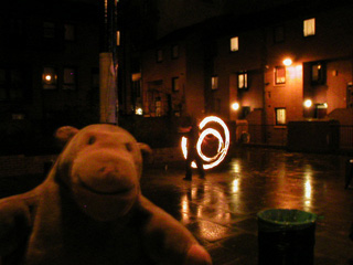 Mr Monkey watching a fire performer outside the Craft and Design Centre