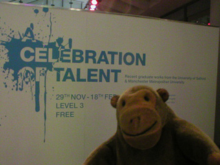 Mr Monkey looking at the sign for the Celebration of Talent exhibition
