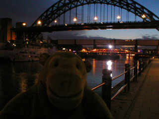 Mr Monkey looking at Newcastle's bridges at dusk