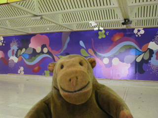 Mr Monkey looking at 'Spank me, Kiss me, Love me' at Byker Metro station