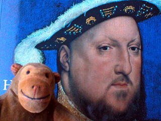 Mr Monkey standing in front of Holbein's painting of Henry VIII