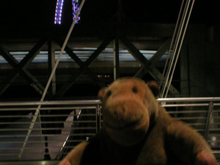 Mr Monkey watching a train cross the Hungerford Bridge
