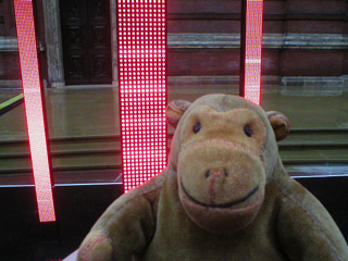 Mr Monkey in front of stacks of lights