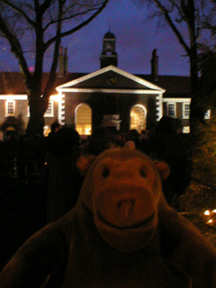 Mr Monkey watching carol singing outside the Geffrye