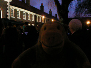 Mr Monkey watching carol singing outside the Geffrye