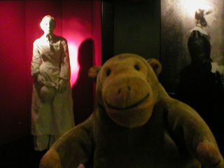 Mr Monkey looking at a model of Scutari nurse and a life size photo of Florence Nightingale