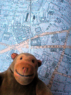 Mr Monkey looking at Stanford's Library Map of London and its suburbs, 1886