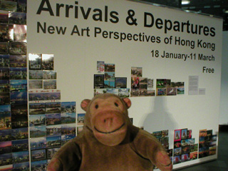 Mr Monkey looking at a wall of postcards