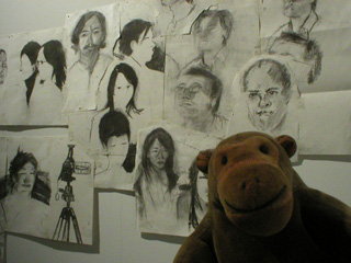 Mr Monkey looking at sketches of Yuen Fong Ling's family