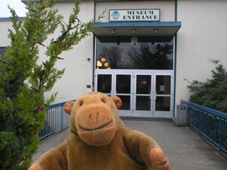 Mr Monkey outside the front doors of MOHAI