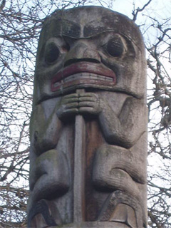 A human figure at the top of the Tsimshian memorial pole