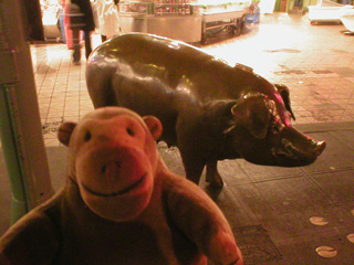 Mr Monkey looking at the Pike Street Market pig